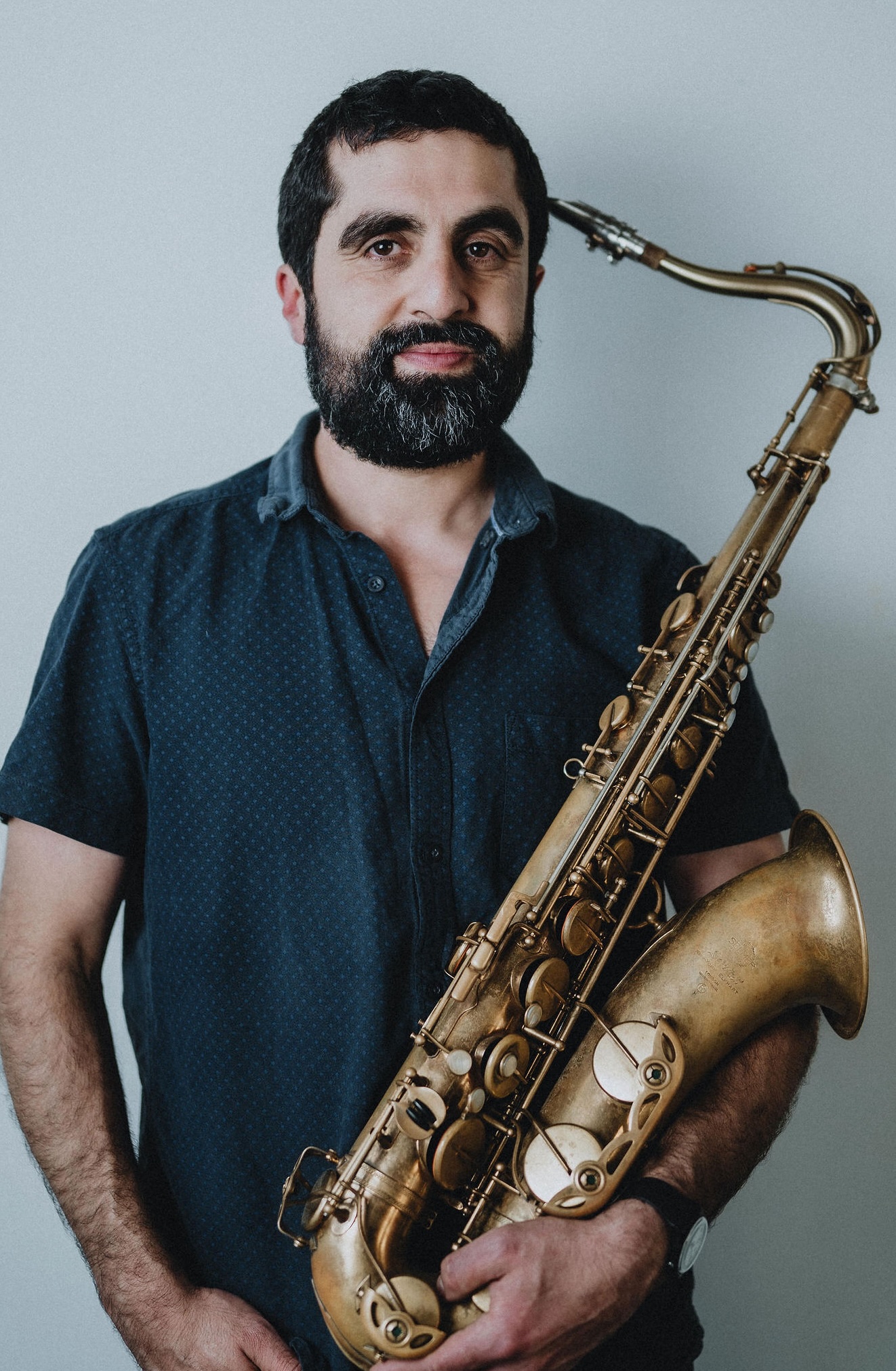 Omid holding a saxophone